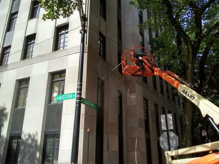 Carbon staining on limestone facade in Chicago before professional cleaning